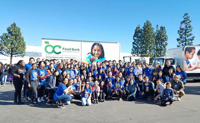 OneOC volunteers gather to pack thousands of boxes of food to be distributed. 