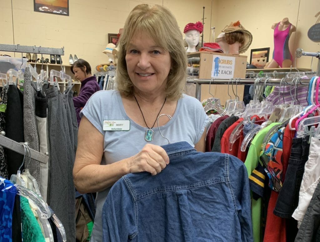 Mary Keehn-Hamacher sorting donated clothes at Memory Lane thrift store./Courtesy Mary Hamacher