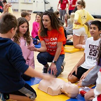 Christy Silva facilitating a CPR-AED training to middle school students and coaches.