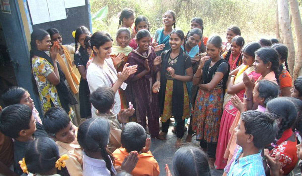 Tanvi Jain Patyal (in white) meets with a group during her work with her nonprofit, Parivartan.