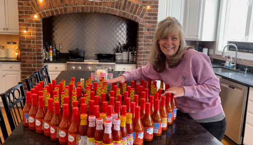 Daily Point of Light Award Honoree Kristen Weinberg shows off 50 bottles of hot sauce she collected to donate to a local soup kitchen through her What’s Your 50? movement