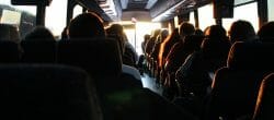 Interior of a bus with silhouetted passengers